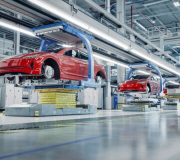 EV Production Line on Advanced Automated Smart Factory  High Performance Electric Car Manufacturing  Car Batteries being Attached to Electric Vehicles on Assembly line  AGV Transport Batteries 